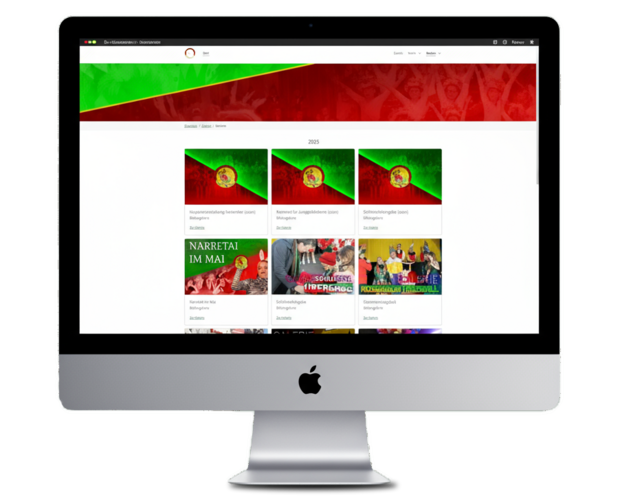 Computerbildschirm mit Webseite, die grün-rote Banner und mehrere Kacheln mit Text und Bildern zeigt.